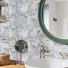 Weiße und graue Marmor-Effekt-Wandfliesen mit goldener Maserung, installiert in einem modernen Badezimmer Produktbild-Vorschau