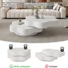 A white, modern coffee table set is shown in a living room setting, with additional images demonstrating weight distribution. Voir les images du produit