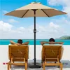 Two people relaxing on lounge chairs on a beach under a large umbrella. Produktbild-Vorschau