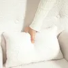 A hand is shown pressing into a plush, cream-colored cushion, likely part of a chair or sofa. Anteprima dell’immagine prodotto