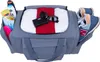 A sports bag filled with various items, including towels, sunglasses, a wallet, toiletries, and shoes. Produktbild-Vorschau