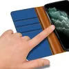 A hand is shown interacting with a blue and brown wallet-style phone case, with a smartphone screen visible. Produktbild-Vorschau