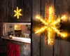 Two illuminated snowflake decorations are attached to a wooden wall, with one prominently displayed on the right and another smaller one visible through a window on the left. Produktbild-Vorschau