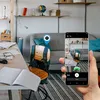 A person is using a smartphone to tag a Samsung Galaxy SmartTag attached to a backpack in a room. Náhľad obrázku produktu