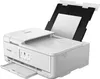 A white Canon PIXMA TS9551Ca printer is shown from a three-quarter front angle with the scanner lid open and paper loaded in the automatic document feeder. Podgląd zdjęcia produktu