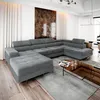 A spacious living room with a large grey sectional sofa and a modern coffee table. Podgląd zdjęcia produktu