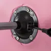 Close-up view of the base of a pink office chair, showing a metal pole inserted into a black mechanism secured by bolts. Produktbild-Vorschau