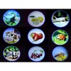A collage of nine circular images, each displaying a different projection from a children's flashlight. The projections include dinosaurs, fruits, insects, and a bee. Náhled obrázku produktu