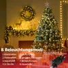 A decorated Christmas tree and mantelpiece with festive lights. Produktbild-Vorschau