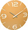 A close-up view of a modern wall clock with a sun yellow face and cut-out numbers. Produktbild-Vorschau