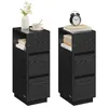 Two black wooden nightstands with drawers and open shelves, each decorated with items on top. Náhled obrázku produktu