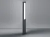 A modern, tall, rectangular LED bollard light with a white illuminated panel, standing on a gray floor against a gray wall. Anteprima dell’immagine prodotto