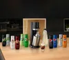 A collection of SodaStream syrup bottles and a SodaStream machine are displayed on a wooden countertop in a modern kitchen setting. Produktbild-Vorschau