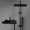 A modern black shower set mounted on a gray wall. Produktbild-Vorschau