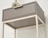 A close-up view of a narrow console table with a beige drawer and cream-colored metal frame. Produktbild-Vorschau
