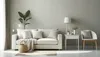 A minimalist living room scene with a white sofa, a side table, and a chair. Produktbild-Vorschau