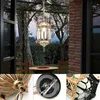 An outdoor patio scene with a hanging lantern, table, and chairs. Voir les images du produit