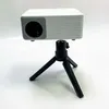 A white mini projector is mounted on a black tripod against a white background. Produktbild-Vorschau