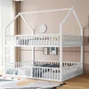 A white bunk bed with a house-shaped frame, set up in a room with a pink wall and curtains. Voir les images du produit