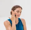 A woman is using a Blackroll Micro foam roller on her face. Anteprima dell’immagine prodotto