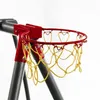 A close-up view of a red basketball hoop with a yellow net, attached to a gray metal frame. Produktbild-Vorschau