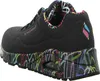 A black Skechers shoe with colorful graffiti-style accents on the sole and collar. Voir les images du produit