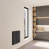 A modern kitchen with dark cabinets and a sleek black radiator mounted on a light-colored wall. Produktbild-Vorschau