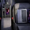 A car's interior with a laptop and phone charging. Anteprima dell’immagine prodotto