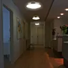 A hallway with multiple ceiling lights, doors, and a chair. Produktbild-Vorschau