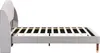 Side view of a gray upholstered bed frame with a wooden slatted mattress support. Podgląd zdjęcia produktu