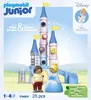 The image shows the packaging of a Playmobil Junior Cinderella's Castle playset, featuring the castle structure, two figures (Cinderella and Prince Charming), and various accessories. The background is a light blue sky with sparkling effects, and the Disne Produktbild-Vorschau