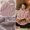 A collage showing a pink sherpa hoodie blanket, a close-up of its texture, and a woman wearing it while reading a book. Produktbild-Vorschau