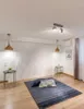 A room with a textured white wall, a rug on the floor, and decorative elements. Produktbild-Vorschau