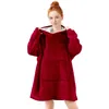 A young woman wearing a red fleece hoodie blanket. Produktbild-Vorschau