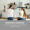 A couple is playfully dancing in a kitchen, holding kitchen utensils like microphones. Produktbild-Vorschau