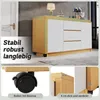 A collage of images showing a white and wood-colored sideboard with drawers and doors, close-ups of its wheels and thickness, and text highlighting its features. Produktbild-Vorschau