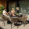 A couple enjoying a meal on a patio with a modern outdoor dining set. Produktbild-Vorschau