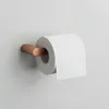 A roll of toilet paper on a copper-colored holder mounted on a light gray wall. Produktbild-Vorschau