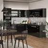 A modern, high-gloss black kitchen with a marble-effect backsplash and a dining table with chairs in the foreground. Produktbild-Vorschau