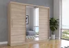 A large wooden wardrobe with mirrored doors stands in a room with a large window. Voir les images du produit