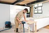 A man is sanding a wooden countertop in a modern kitchen setting. Anteprima dell’immagine prodotto