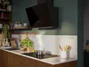 A modern kitchen scene with an induction hob and extractor fan. Voir les images du produit