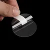 A hand is peeling a protective film off a clear, circular screen protector. Produktbild-Vorschau