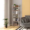 A tall, slender bookshelf filled with books and decorative items is placed next to a gray sofa in a room. Produktbild-Vorschau