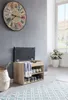 A shoe bench with storage and a padded seat is placed in a hallway next to a basket and a large wall clock. Produktbild-Vorschau