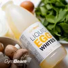 A bottle of liquid egg whites is shown with other ingredients like mushrooms, spinach, and an egg in the background. Podgląd zdjęcia produktu