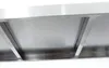 Close-up view of the underside of a stainless steel shelf with support beams. Voir les images du produit