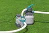 A sand filter pump system for a pool is set up on a grassy lawn. Produktbild-Vorschau