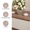 A close-up view of a coffee table with a vase of flowers and candles, with feature icons on the left. Voir les images du produit