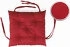 A red tufted seat cushion with ties, shown against a white background. A circular inset shows a close-up of the fabric texture. Produktbild-Vorschau